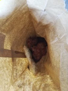 Samosas and pakoras in brown paper bag